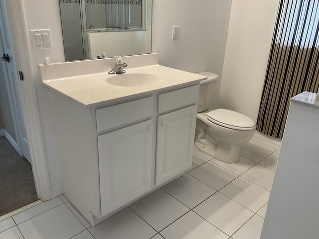 bathroom featuring vanity, tile patterned floors, and toilet