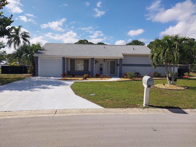 ranch-style home featuring a front lawn and a garage