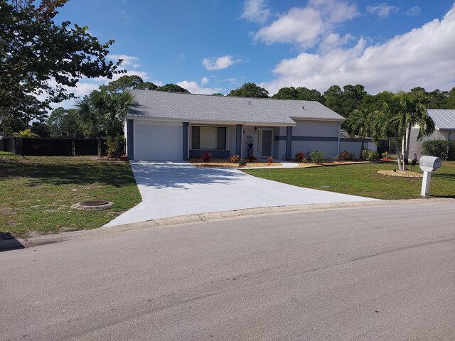 ranch-style house with a front yard and a garage