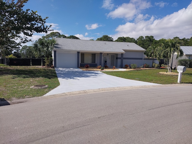 single story home featuring a garage and a front yard