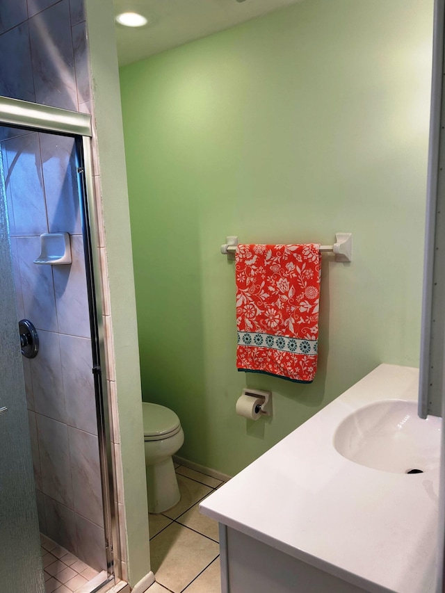 bathroom featuring walk in shower, tile patterned floors, toilet, and vanity