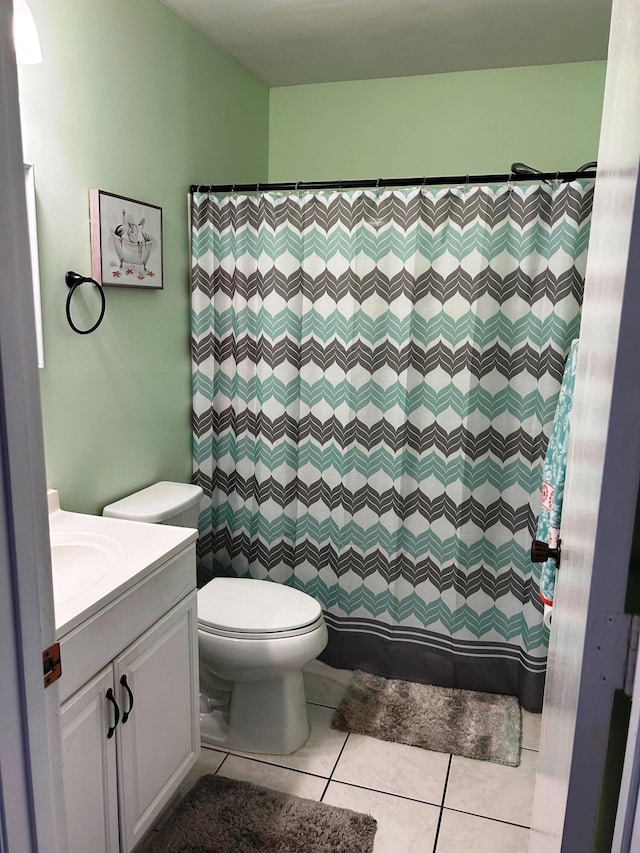 bathroom with tile patterned flooring, vanity, a shower with curtain, and toilet