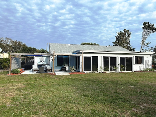 back of property featuring a patio and a lawn