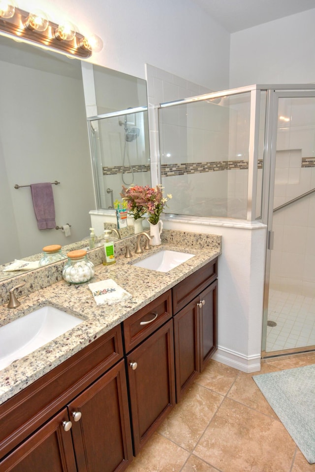 bathroom featuring vanity, tile patterned floors, and walk in shower