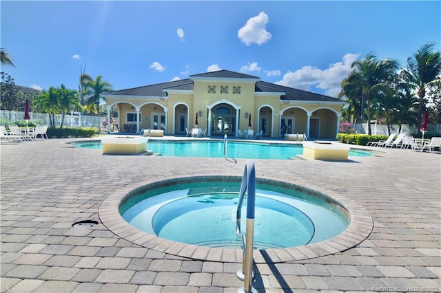 view of swimming pool with a community hot tub and a patio