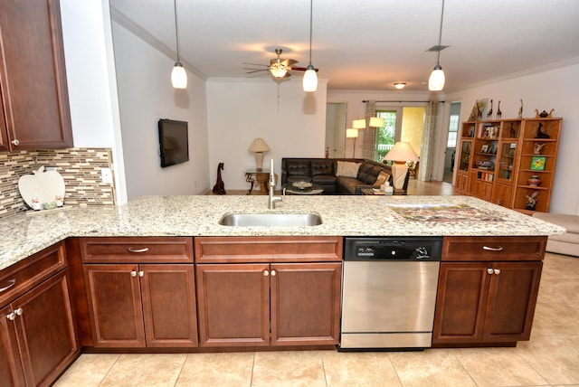 kitchen featuring tasteful backsplash, pendant lighting, sink, and stainless steel dishwasher