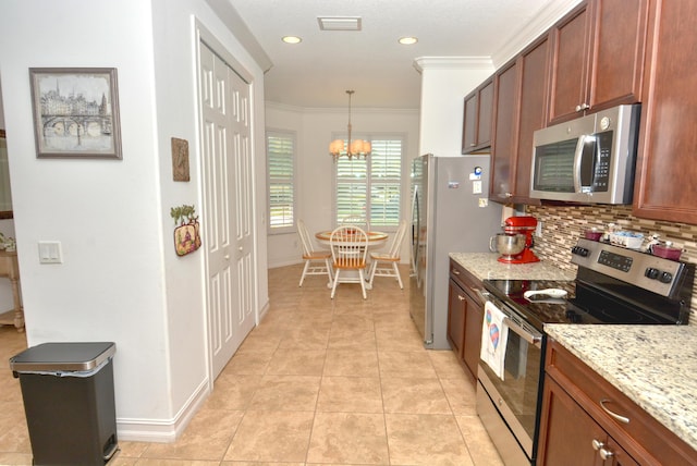 kitchen featuring light stone counters, decorative light fixtures, ornamental molding, a notable chandelier, and stainless steel appliances