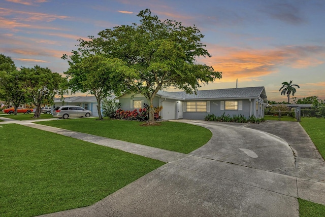 ranch-style home featuring a yard