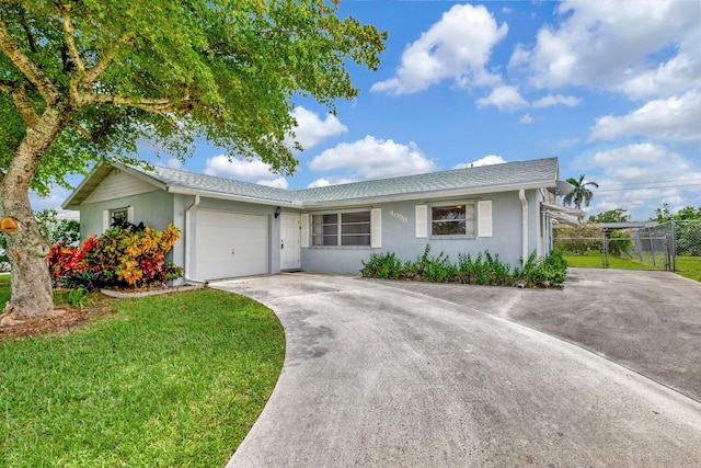 single story home with a front yard and a garage