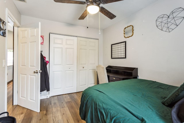 bedroom featuring ceiling fan, light hardwood / wood-style floors, and a closet