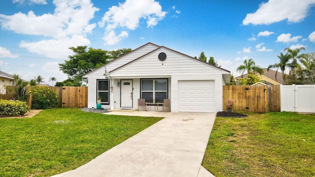 view of front of home with a front yard and a garage