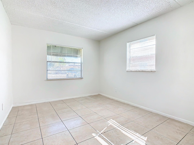 Xx Michigan Court, Saint Cloud, FL 34769 - unfurnished bedroom featuring light tile patterned floors, visible vents, a closet, and a textured ceiling