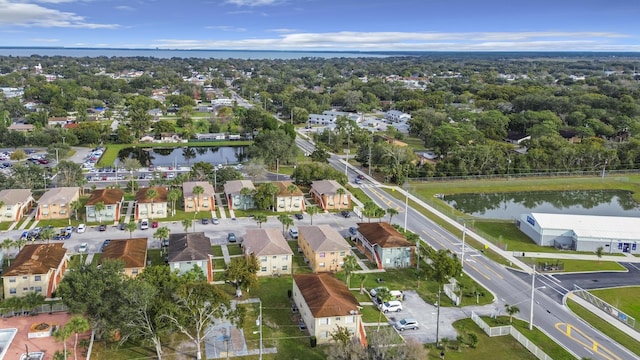 drone / aerial view featuring a residential view and a water view