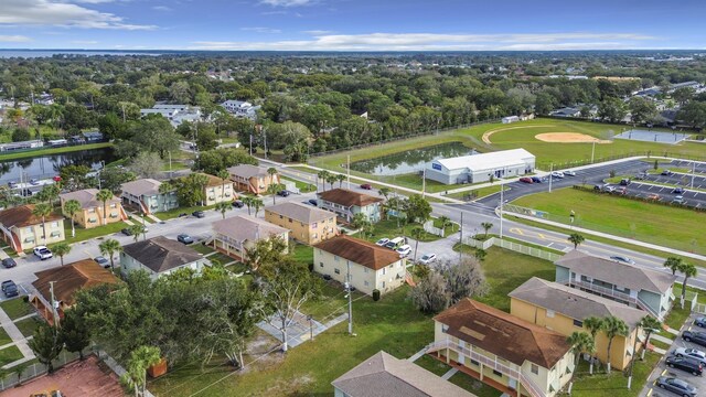 drone / aerial view with a residential view and a water view