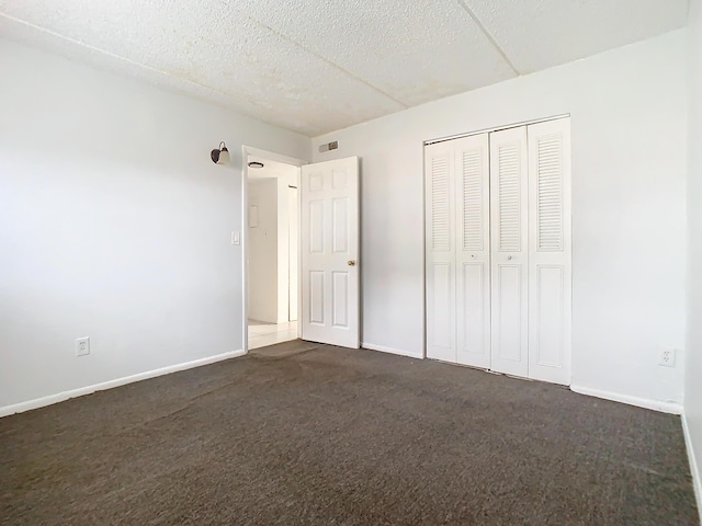 Xx Michigan Court, Saint Cloud, FL 34769 - unfurnished bedroom with visible vents, baseboards, and dark carpet