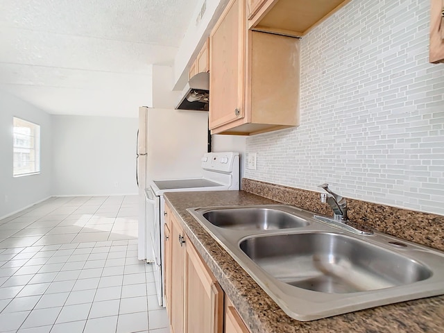 kitchen featuring light brown cabinetry, light tile patterned floors, electric stove, a textured ceiling, and a sink