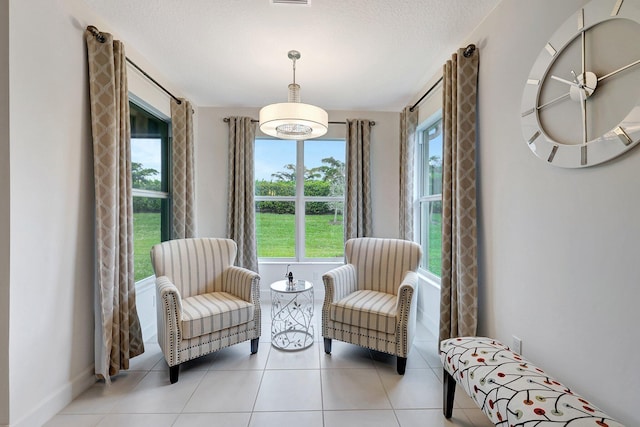 sitting room featuring a textured ceiling and light tile patterned floors