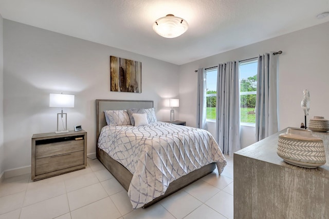 tiled bedroom featuring a textured ceiling