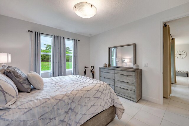 tiled bedroom with a textured ceiling