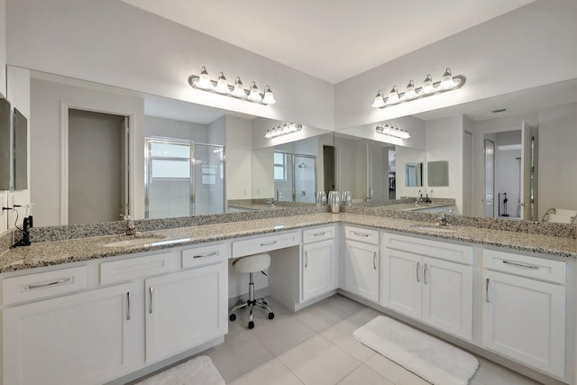 bathroom featuring walk in shower, vanity, and tile patterned floors