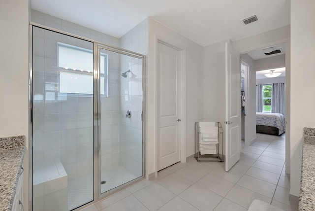 bathroom featuring vanity, tile patterned flooring, and a shower with shower door