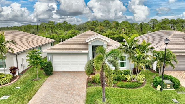 single story home featuring a front yard and a garage