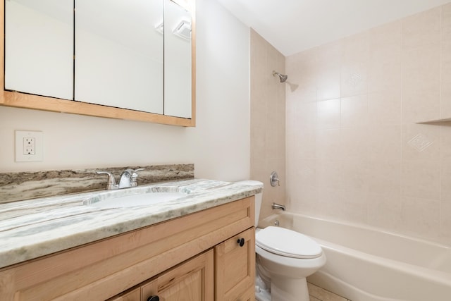 full bathroom featuring toilet, tiled shower / bath combo, and vanity