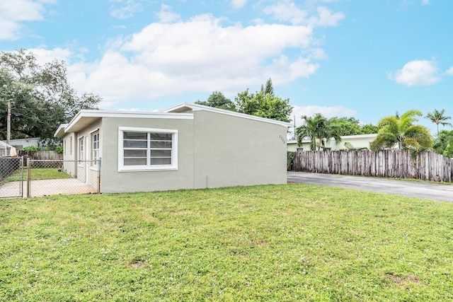 view of side of home with a lawn