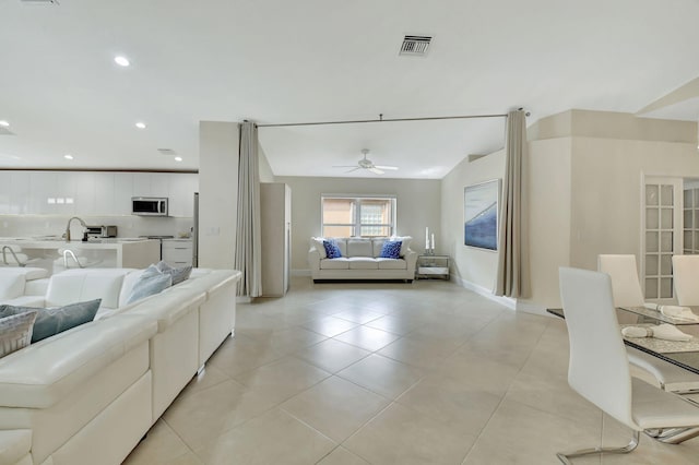 tiled living room featuring ceiling fan