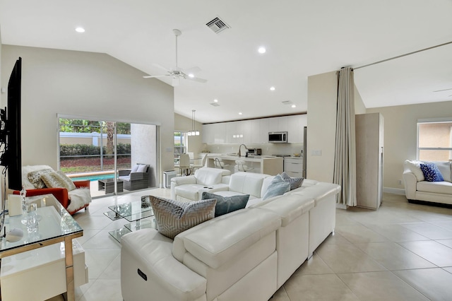 tiled living room featuring lofted ceiling and ceiling fan