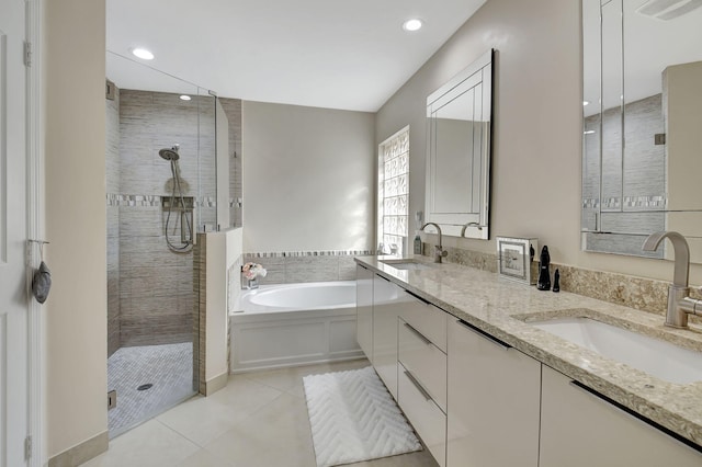 bathroom with tile patterned flooring, plus walk in shower, and vanity