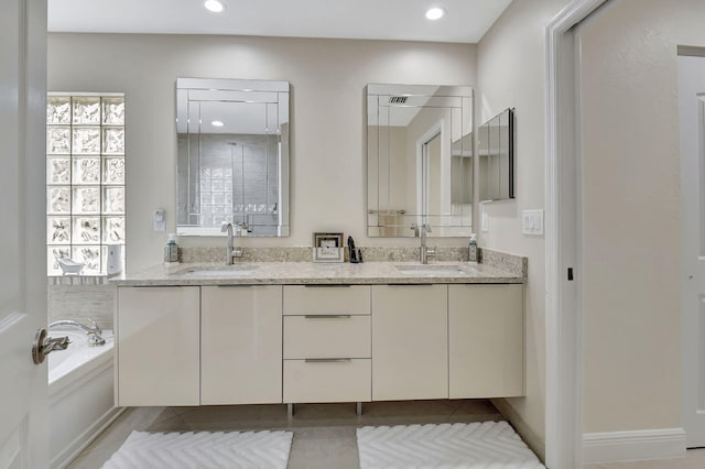 bathroom featuring vanity, a bathtub, and tile patterned floors