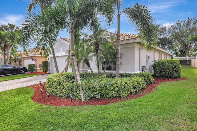 view of front of property with a front lawn and a garage