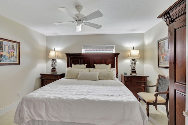 bedroom featuring ceiling fan and light carpet