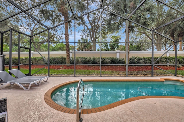 view of swimming pool with a patio area and glass enclosure