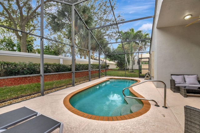 view of swimming pool featuring a patio area and glass enclosure