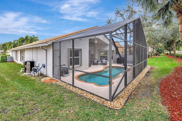 back of property featuring a lanai, a patio, and a lawn