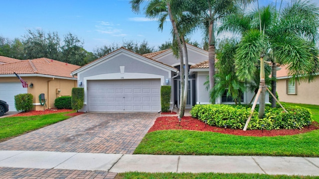 view of front of home with a front yard and a garage