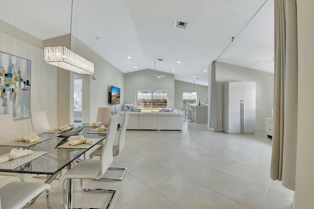 dining room with vaulted ceiling and ceiling fan with notable chandelier