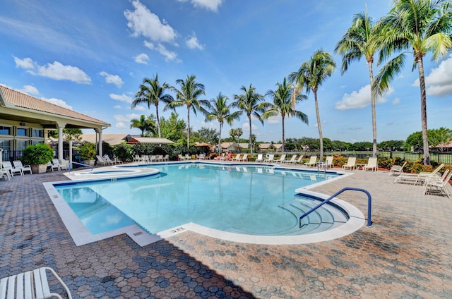 view of swimming pool with a community hot tub and a patio