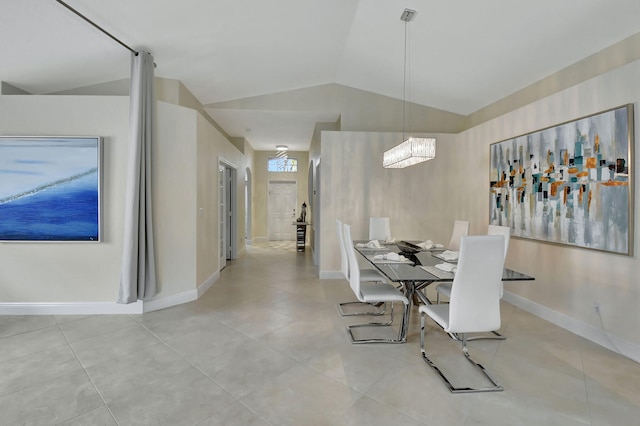 dining room featuring lofted ceiling, light tile patterned flooring, and a notable chandelier