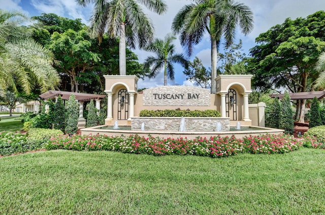 community sign featuring a yard