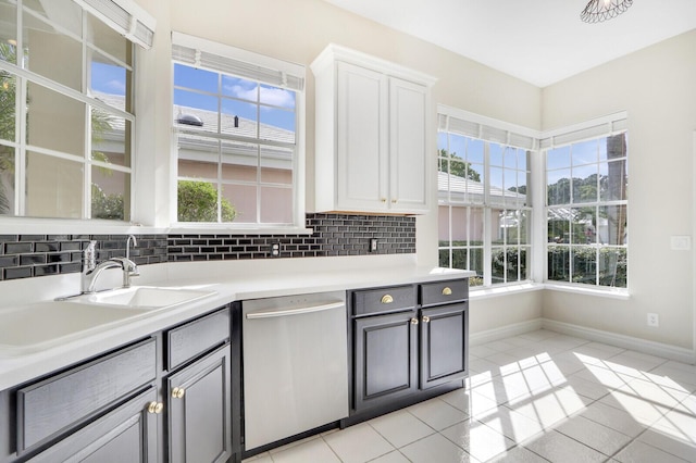 kitchen featuring stainless steel dishwasher, white cabinetry, light tile patterned floors, and gray cabinets