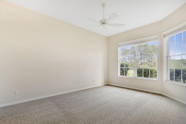 carpeted spare room featuring ceiling fan