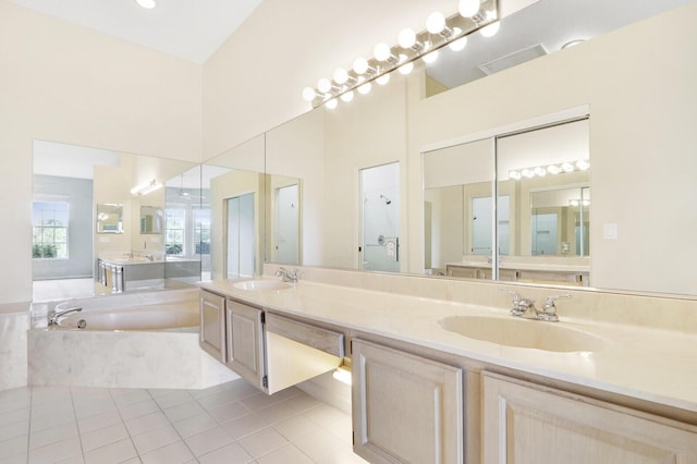 bathroom with tile patterned flooring, shower with separate bathtub, and vanity