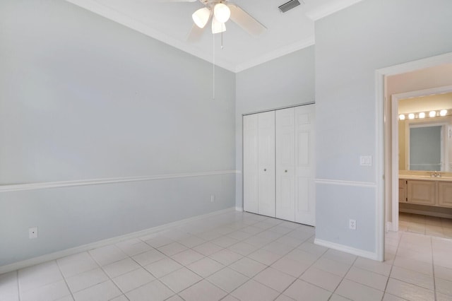 unfurnished bedroom featuring light tile patterned floors, a closet, ornamental molding, and ceiling fan