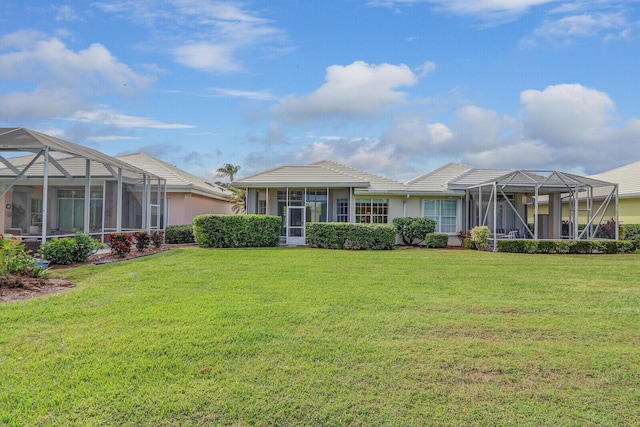 view of front of property featuring glass enclosure and a front lawn