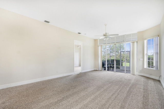 carpeted spare room with ceiling fan