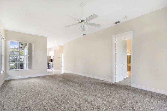 unfurnished living room featuring light colored carpet and ceiling fan