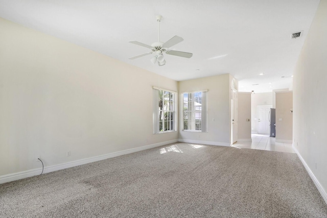 unfurnished room with ceiling fan and light colored carpet